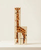 Wooden blocks with giraffe illustrations stacked on a white surface